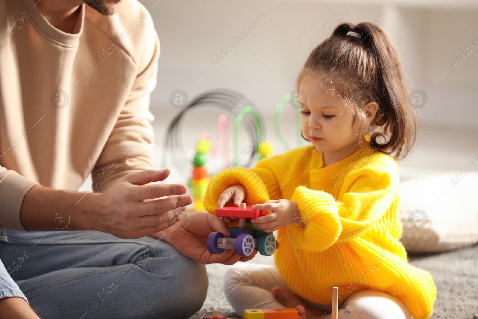 Photo of Father playing with his child at home