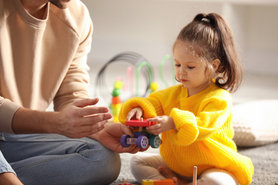 Photo of Father playing with his child at home