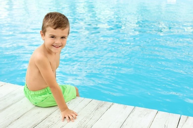 Little child near outdoor swimming pool. Dangerous situation