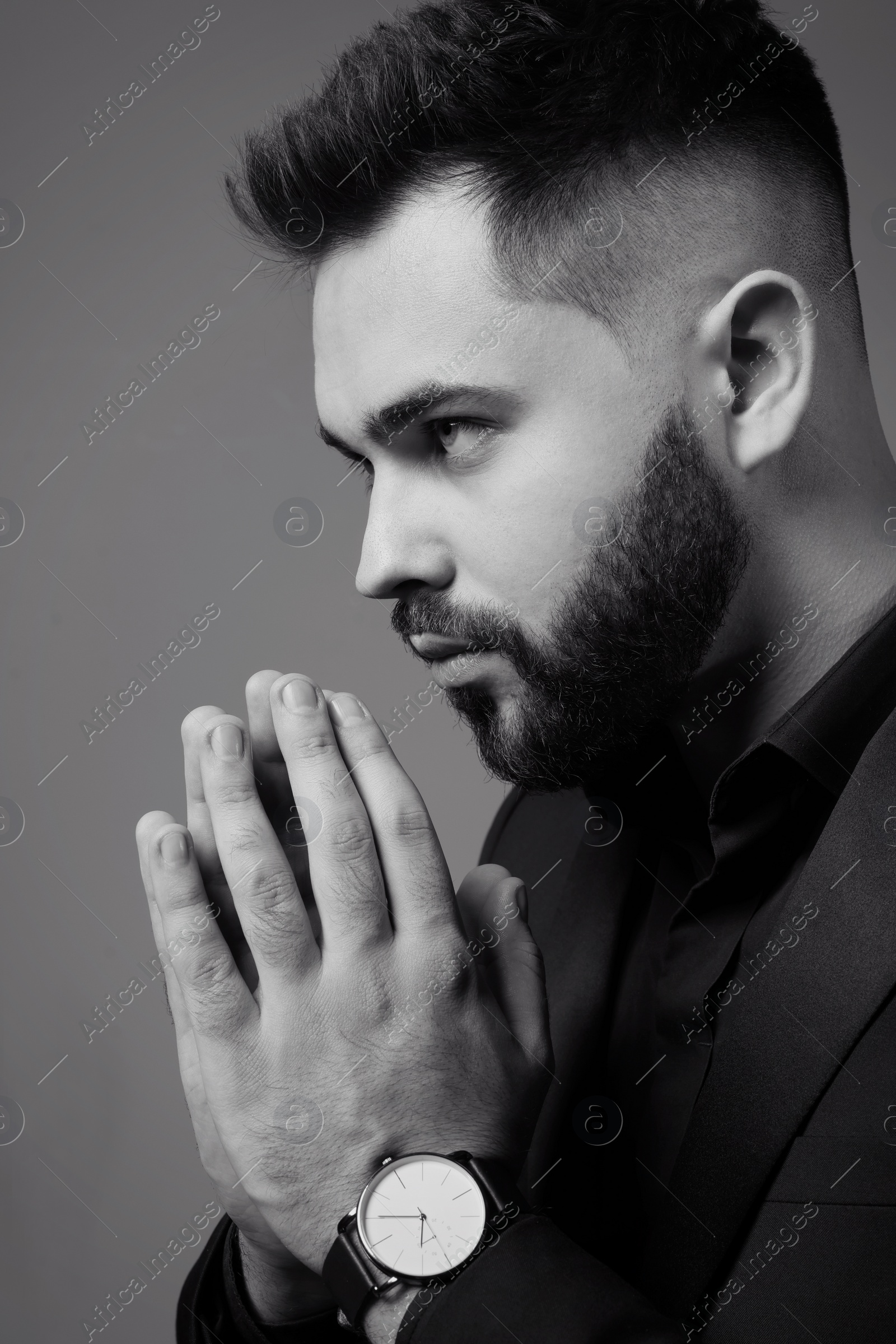 Photo of Handsome bearded man on grey background. Black and white effect