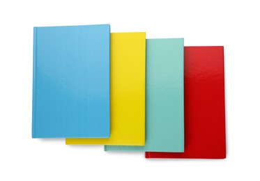 Photo of Different colorful hardcover planners on white background, top view