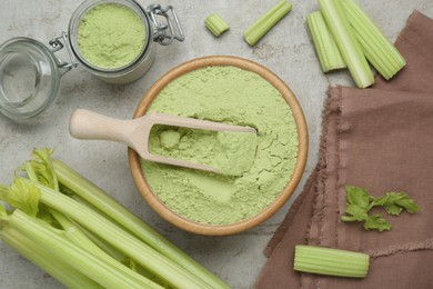 Photo of Natural celery powder and fresh stalks on grey table, flat lay