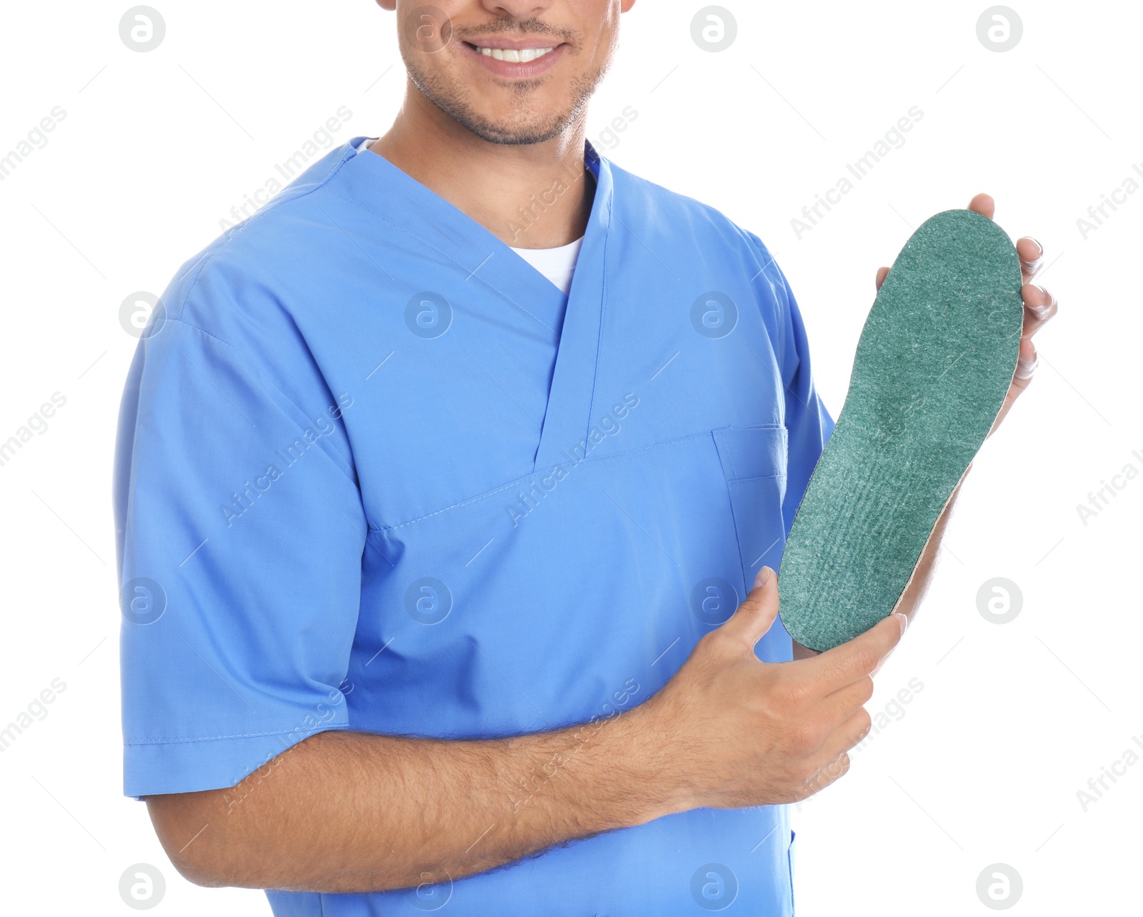 Photo of Male orthopedist showing insole on white background, closeup