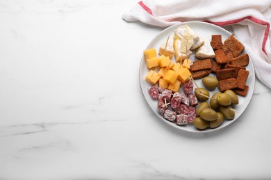 Toothpick appetizers. Pieces of sausage, cheese and olives on white table, top view with space for text