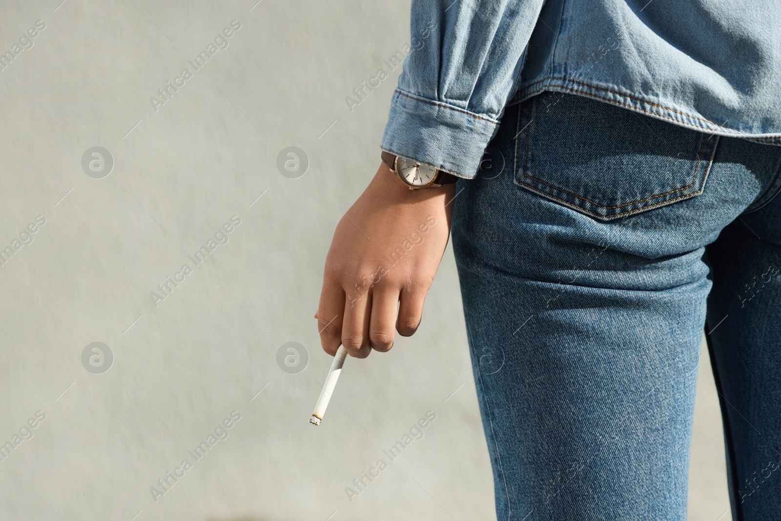 Photo of Woman with cigarette outdoors, closeup. Space for text