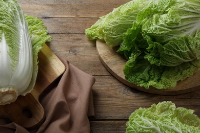 Photo of Fresh ripe Chinese cabbages on wooden table