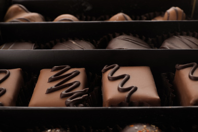 Photo of Many different chocolate candies in box, closeup