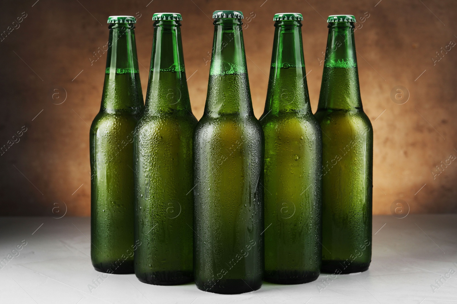 Photo of Many bottles of beer on white table