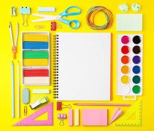 Flat lay composition with different school stationery on yellow background, space for text. Back to school