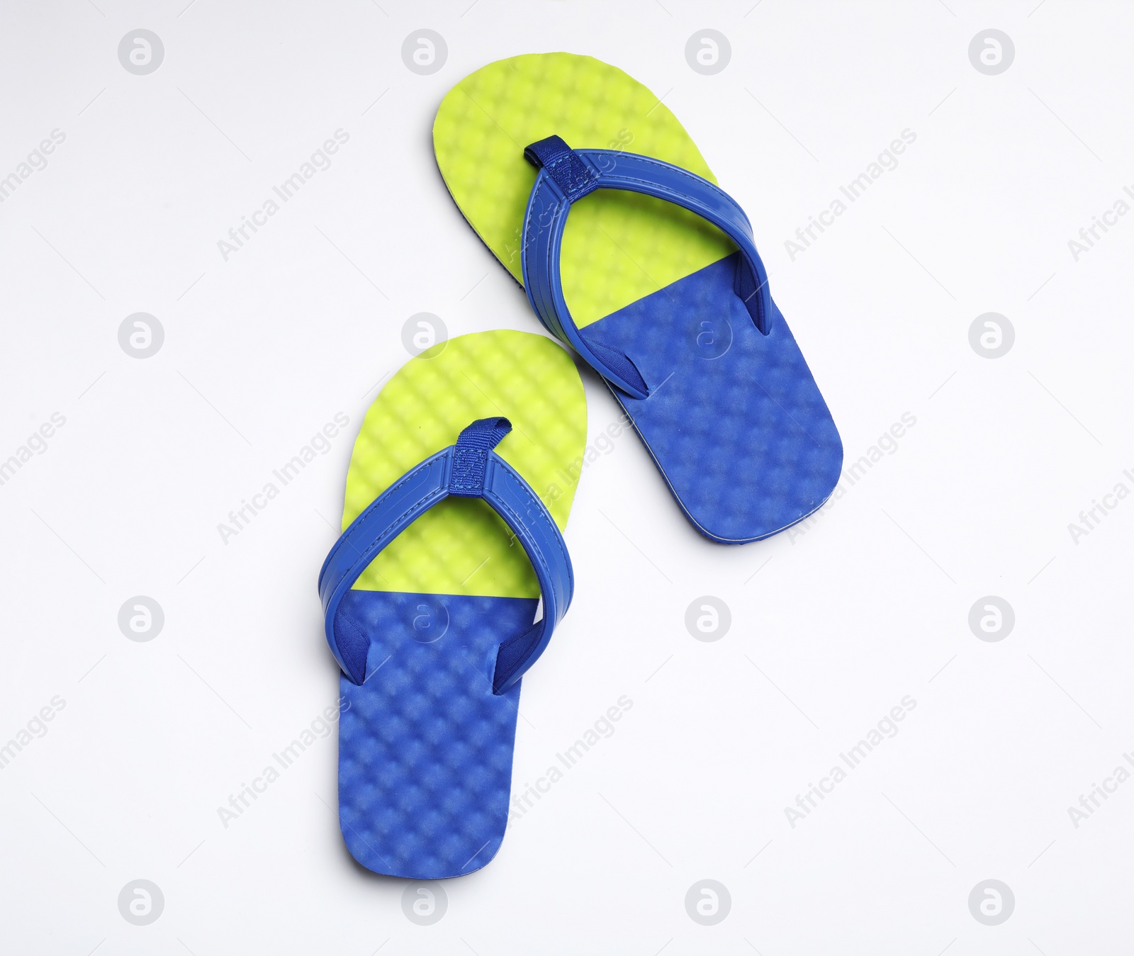 Photo of Pair of flip flops on white background, top view. Beach accessories