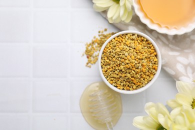 Photo of Flat lay composition with fresh bee pollen granules and honey on white tiled table. Space for text