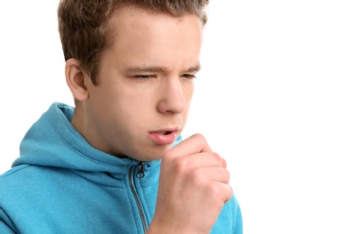 Photo of Teenage boy suffering from cough isolated on white