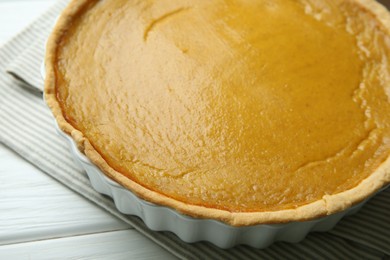 Photo of Delicious pumpkin pie on white wooden table, closeup