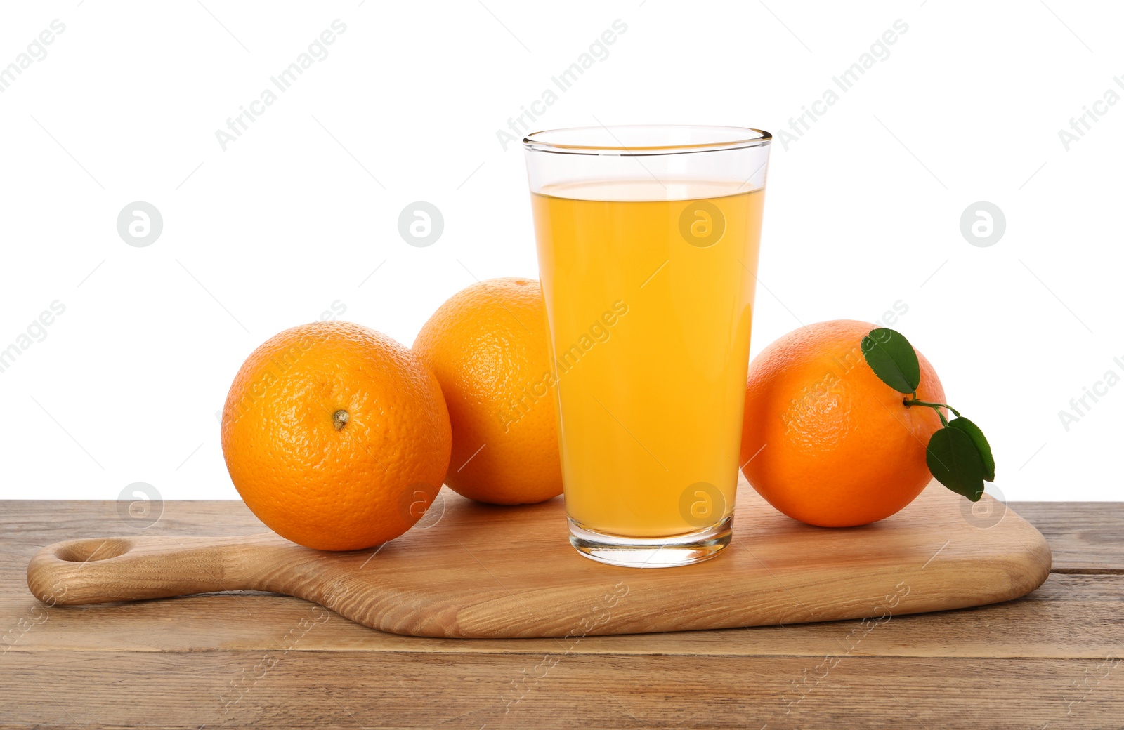 Photo of Fresh oranges and glass of juice on wooden table against white background