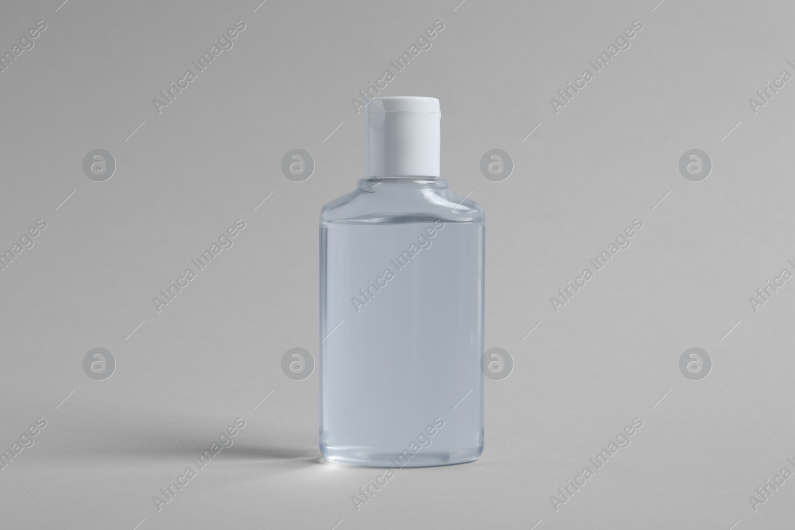 Photo of Bottle of cosmetic product on light grey background