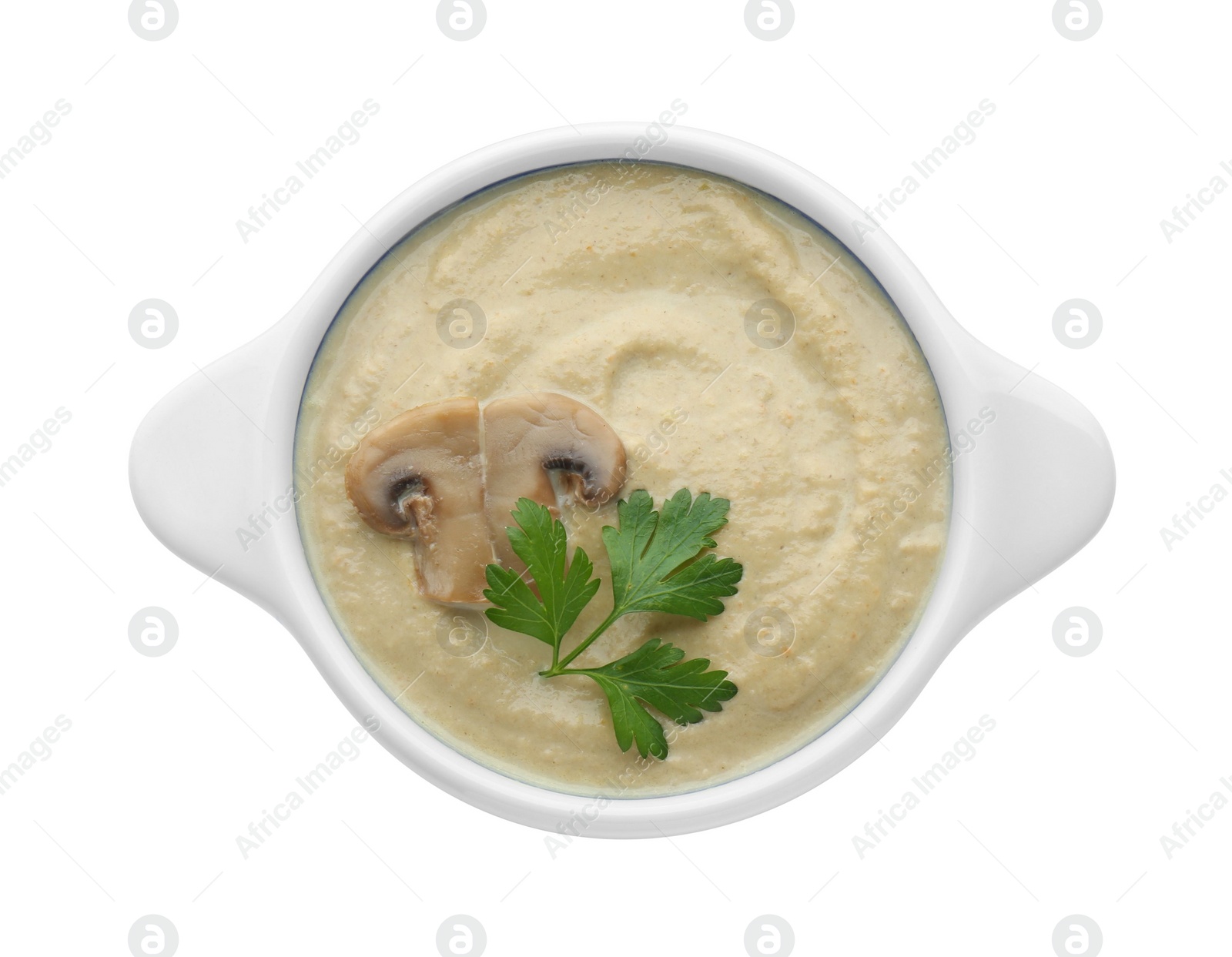 Photo of Delicious mushroom cream soup with parsley isolated on white, top view