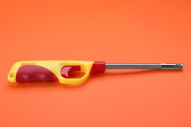 One bright gas lighter on orange background