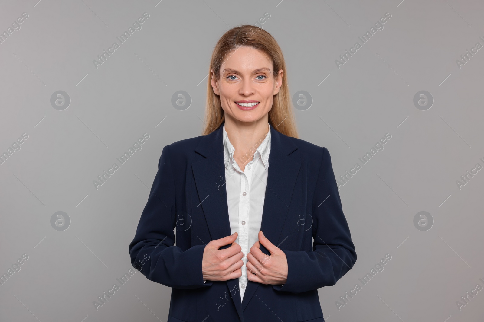 Photo of Happy real estate agent on grey background