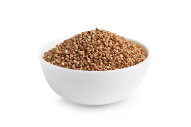 Bowl with uncooked buckwheat on white background