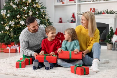 Photo of Happy family with Christmas gifts at home