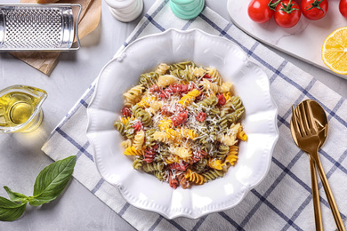 Photo of Delicious colorful pasta served on light table, flat lay