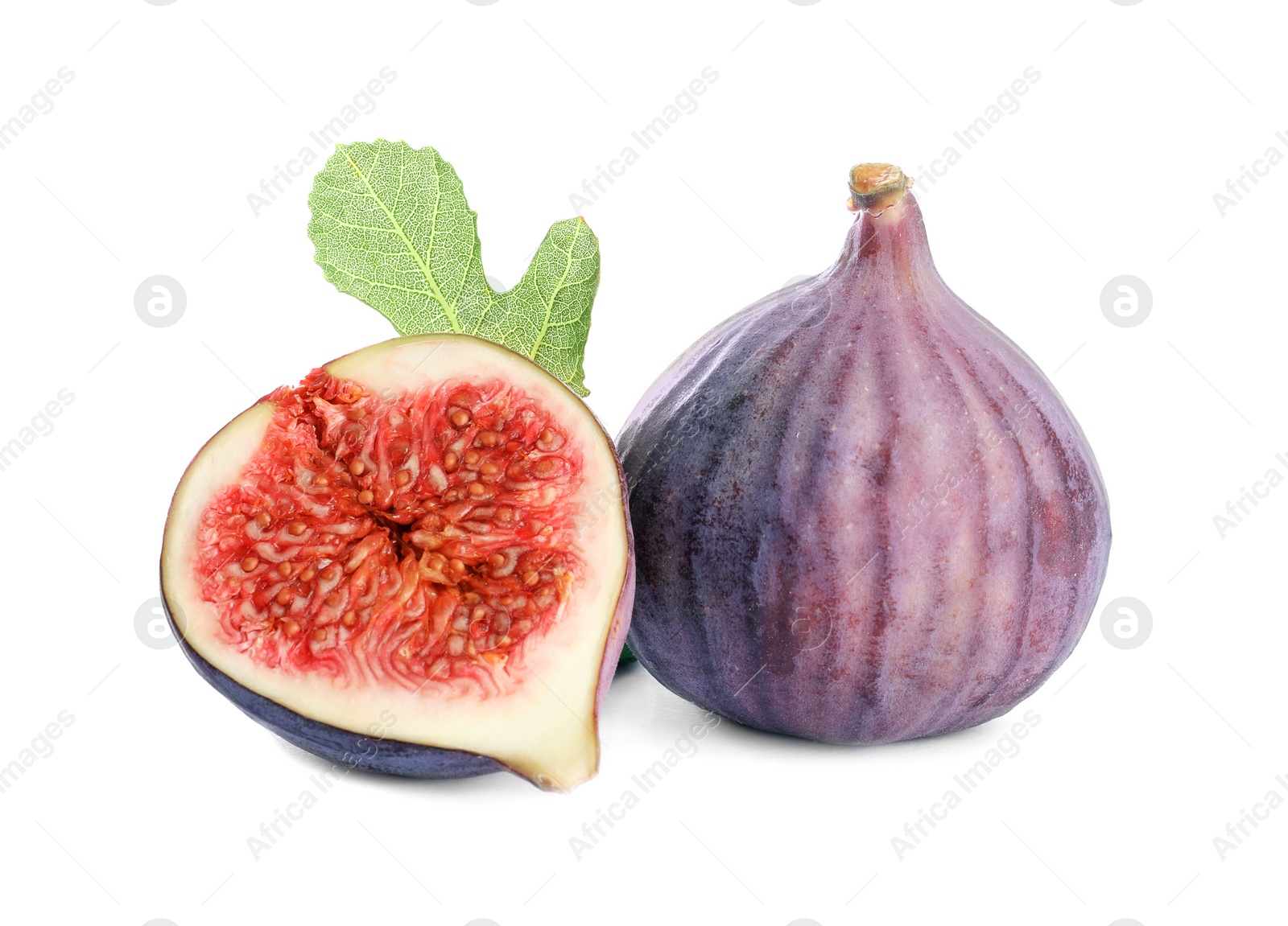 Photo of Whole and cut purple figs on white background