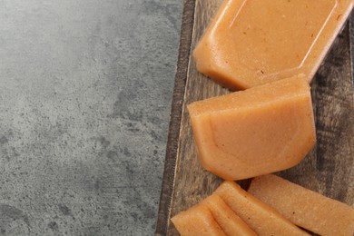 Tasty sweet quince paste on grey table, top view. Space for text