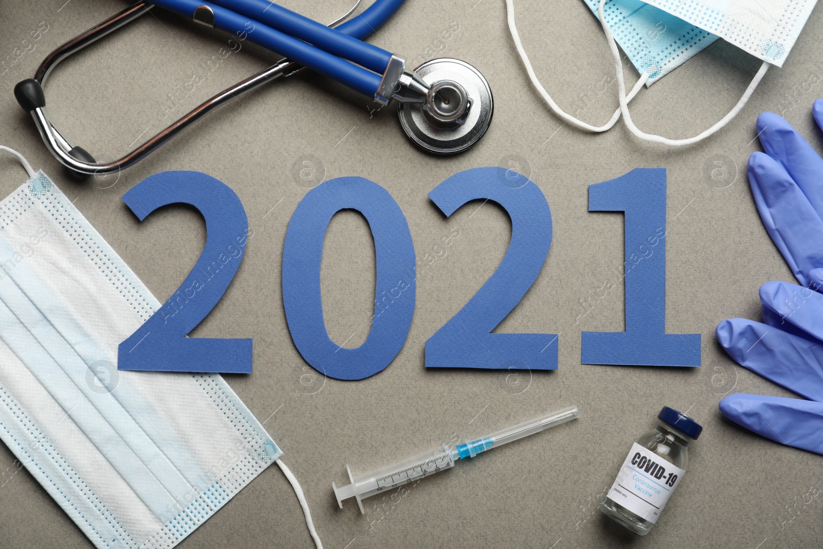 Photo of Flat lay composition with coronavirus vaccine and number 2021 on grey background