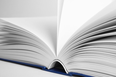 Closeup view of open book on white background