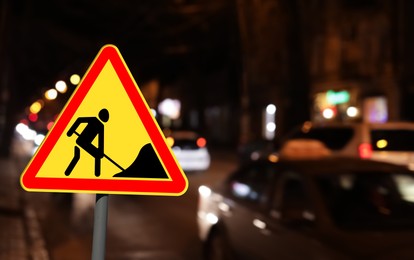 Image of Traffic sign Road Works on city street in night. Bokeh effect