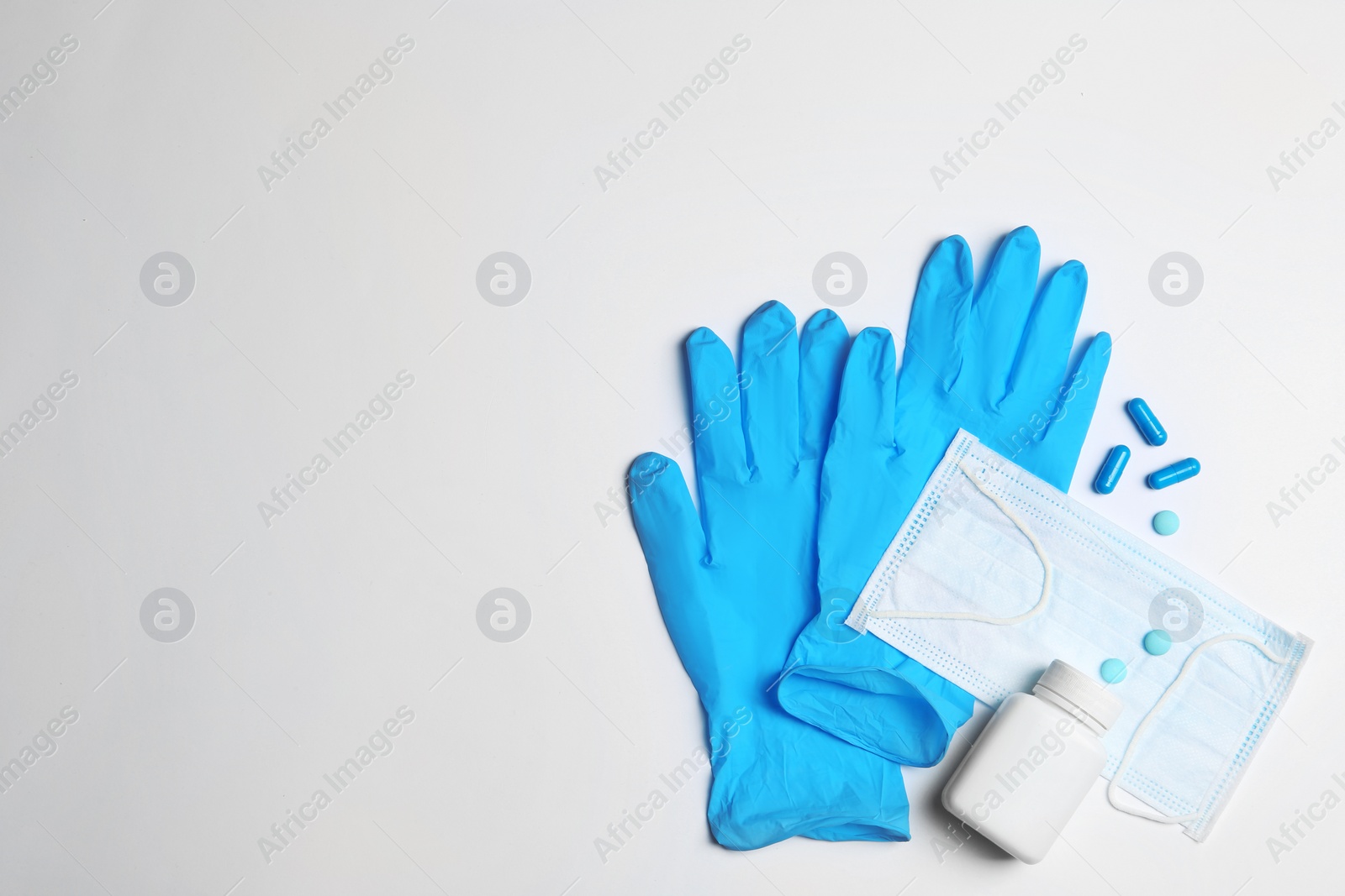 Photo of Flat lay composition with medical gloves on white background. Space for text