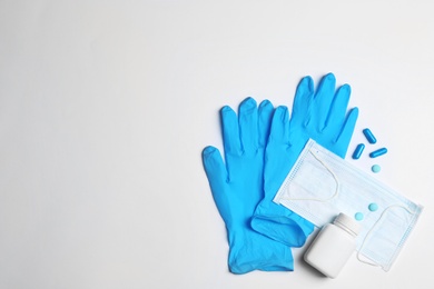 Photo of Flat lay composition with medical gloves on white background. Space for text