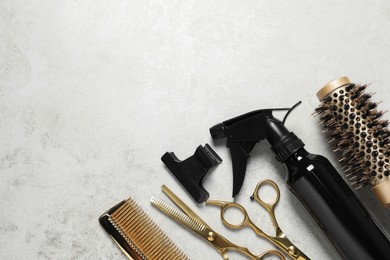 Professional hair dresser tools on grey textured background, flat lay. Space for text