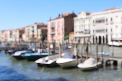 VENICE, ITALY - JUNE 13, 2019: Blurred view of Grand Canal with different boats at pier