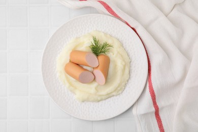 Photo of Delicious boiled sausages, mashed potato and dill on white tiled table, top view
