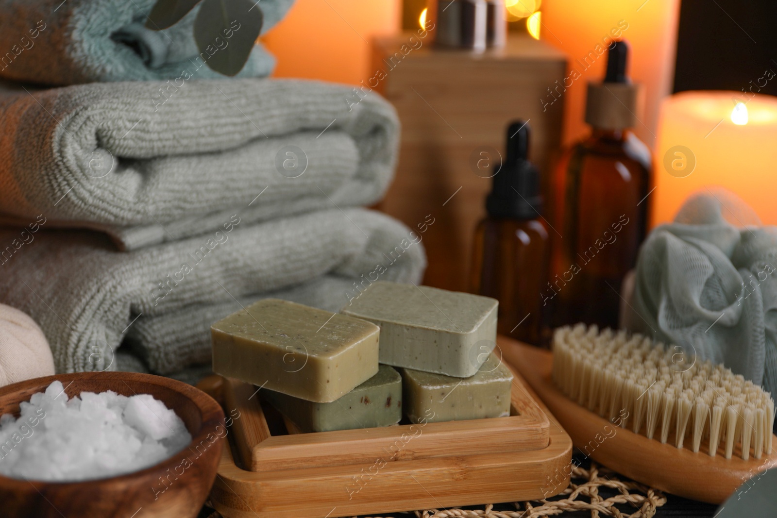 Photo of Beautiful composition with different spa products on table against blurred lights, closeup