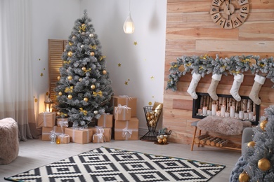 Photo of Stylish room interior with beautiful Christmas tree and decorative fireplace