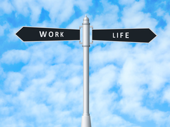 Image of Signpost against beautiful blue sky. Concept of balance between work and life