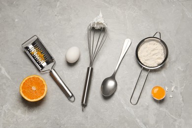 Flat lay composition with different tools for cooking on light grey marble table