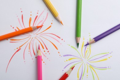 Abstract drawing and colorful pencils on white background, top view