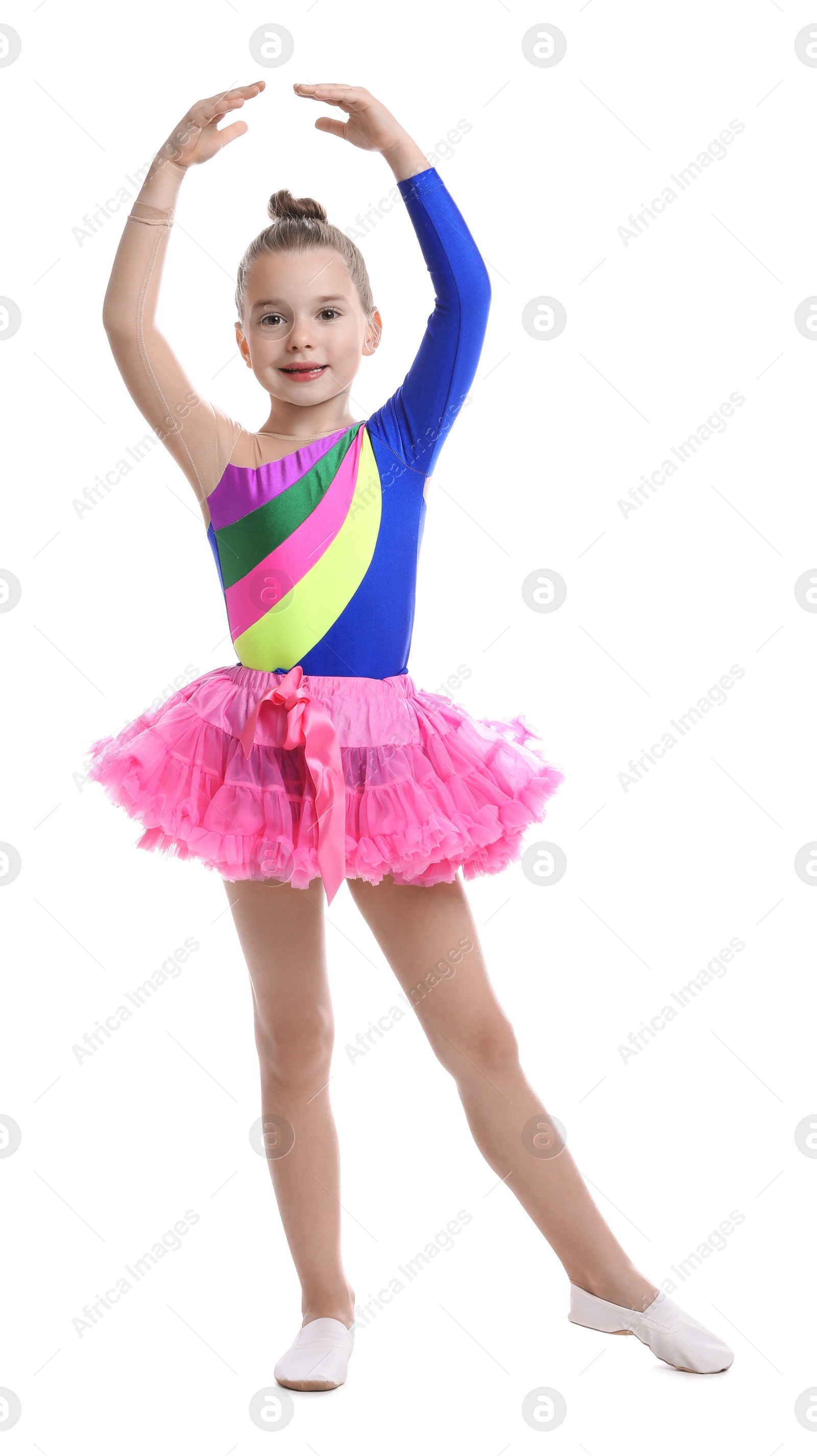 Photo of Cute little girl in costume dancing on white background