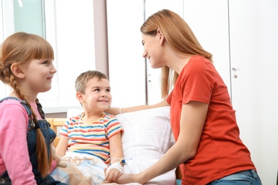 Happy family visiting little child in hospital