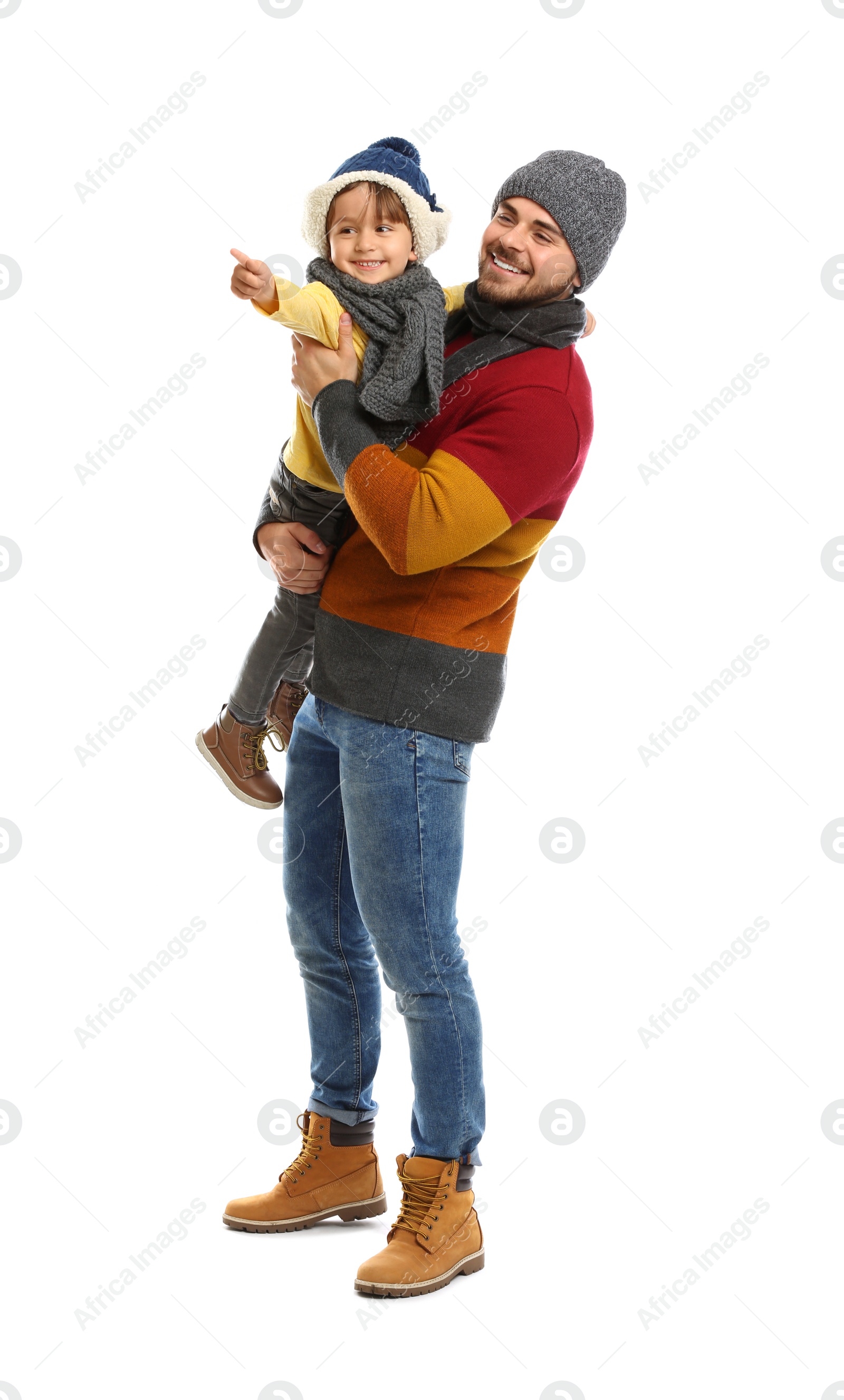 Photo of Happy father and son in warm clothes on white background. Winter vacation