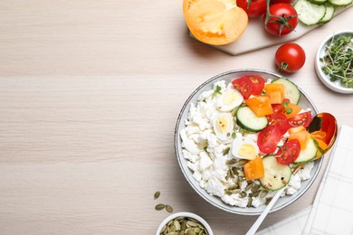 Fresh cottage cheese with vegetables, seeds and eggs in bowl on wooden table, flat lay. Space for text