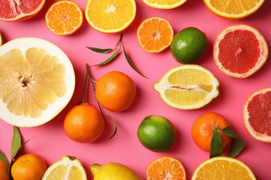 Photo of Different citrus fruits on color background, top view