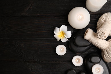 Spa composition with stones on wooden background, flat lay. Space for text