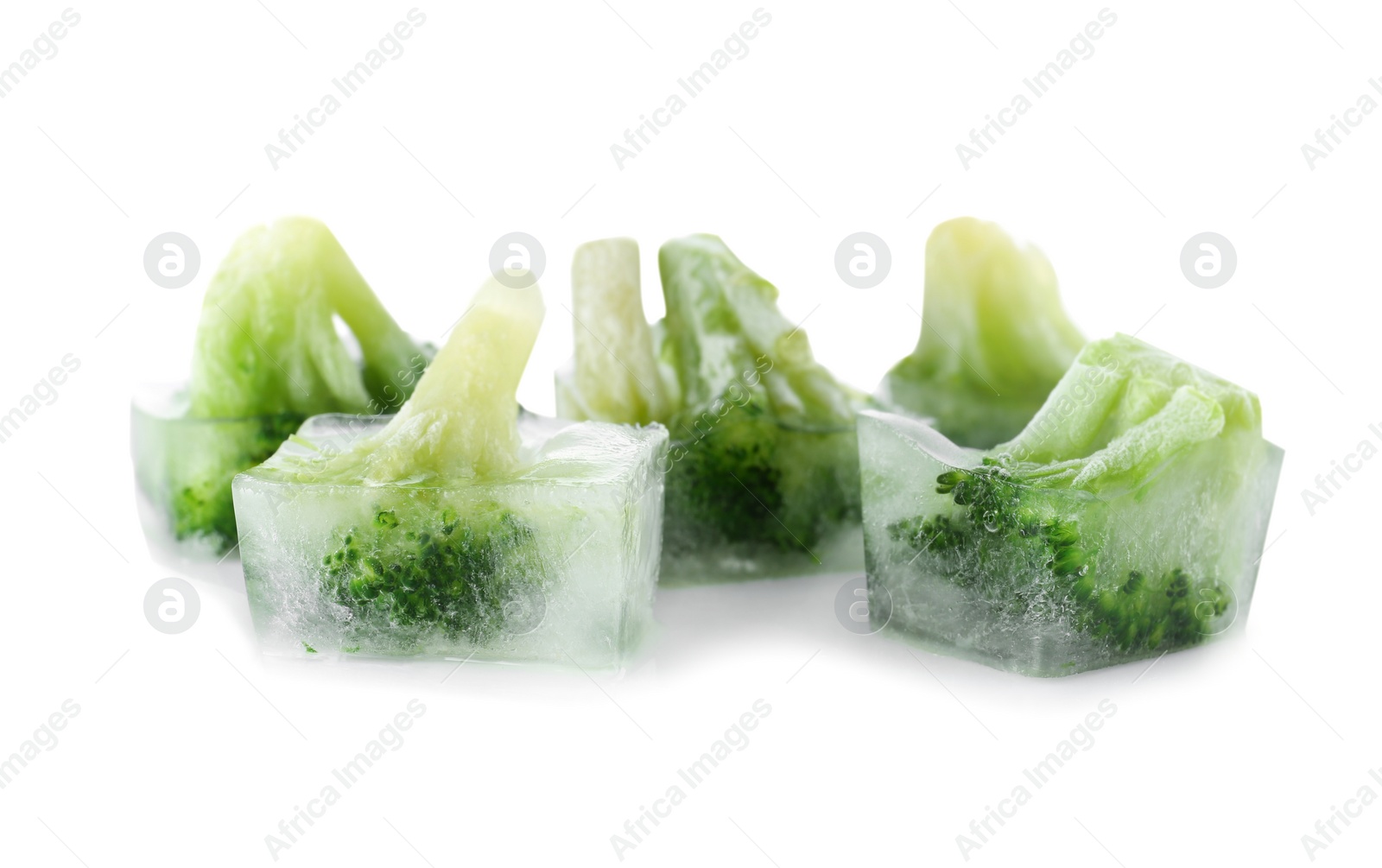 Photo of Fresh broccoli in ice cubes on white background. Frozen vegetables