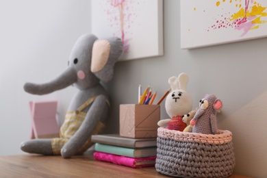 Stationery and toys on wooden table in children's room. Interior design