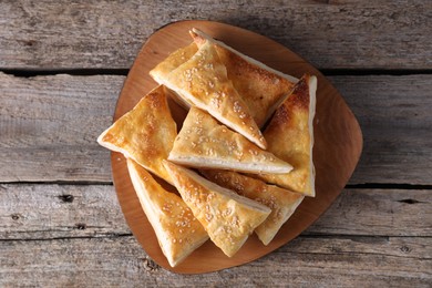 Photo of Delicious puff pastry on wooden table, top view