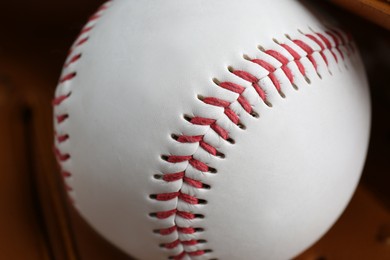 Photo of Leather baseball glove with ball, closeup. Sportive equipment